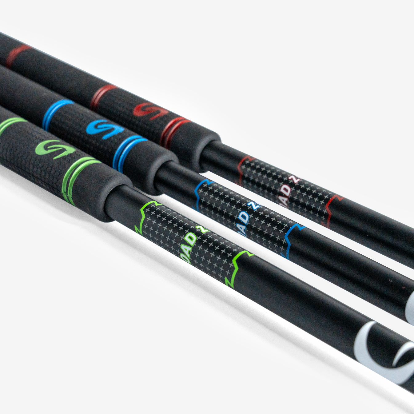 Close-up of three black super speed stick shafts with green, blue, and red outline