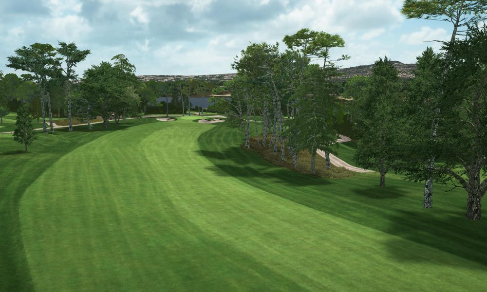 Golf course with green grass and trees under a cloudy sky