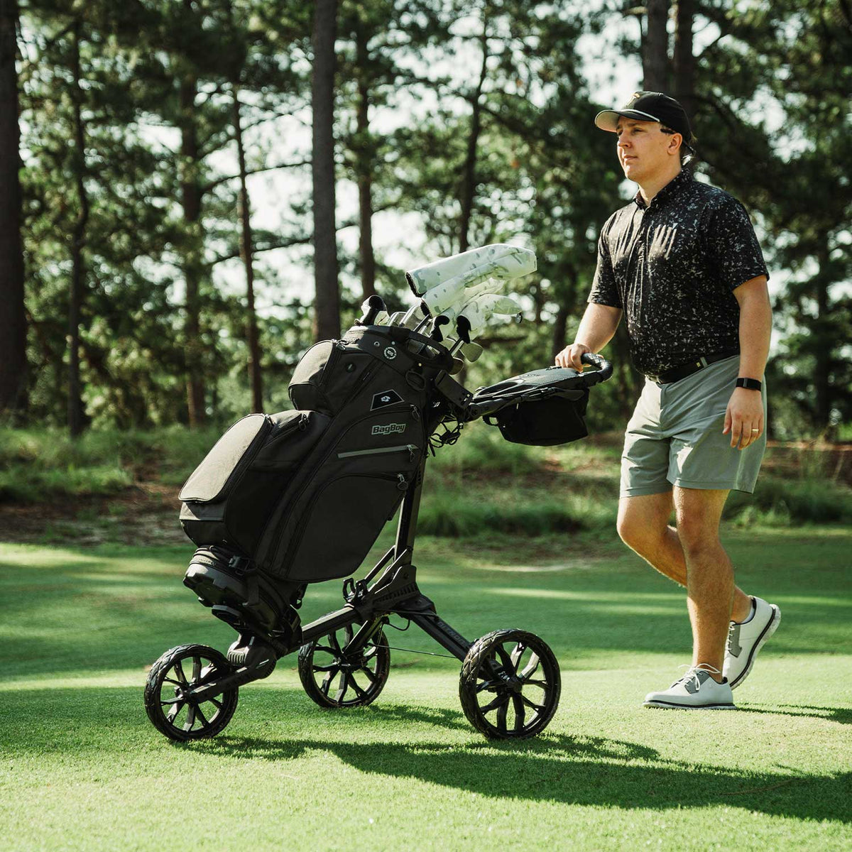 Bag Boy Nitron golf cart, black and slate, lifestyle photo