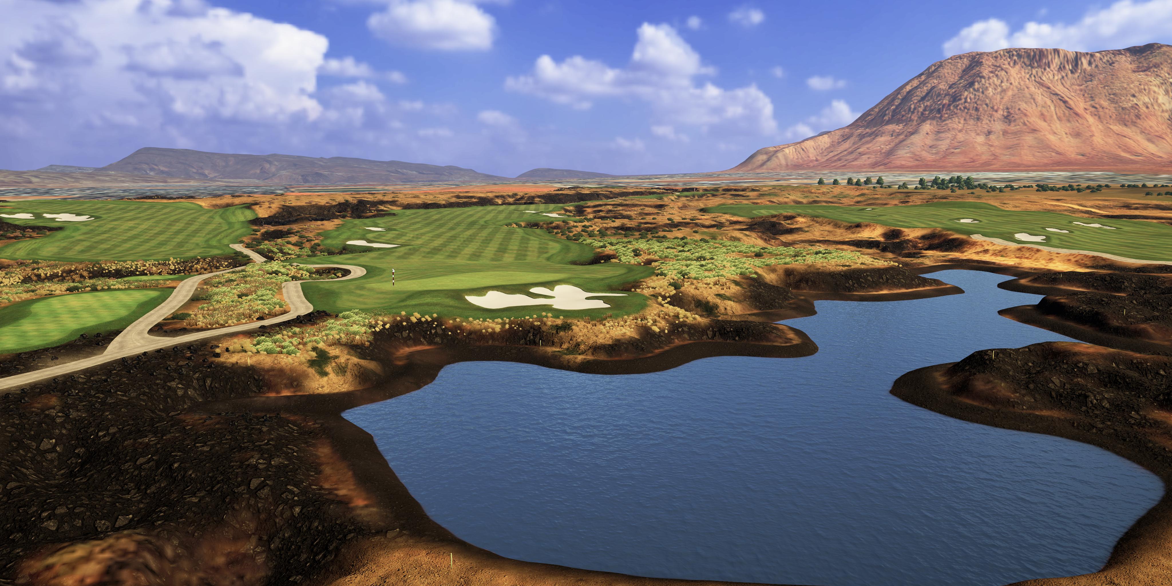 Golf course with water hazard and mountainous landscape