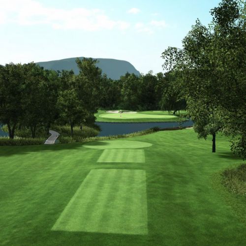 Golf course with green grass, trees, and a clear sky