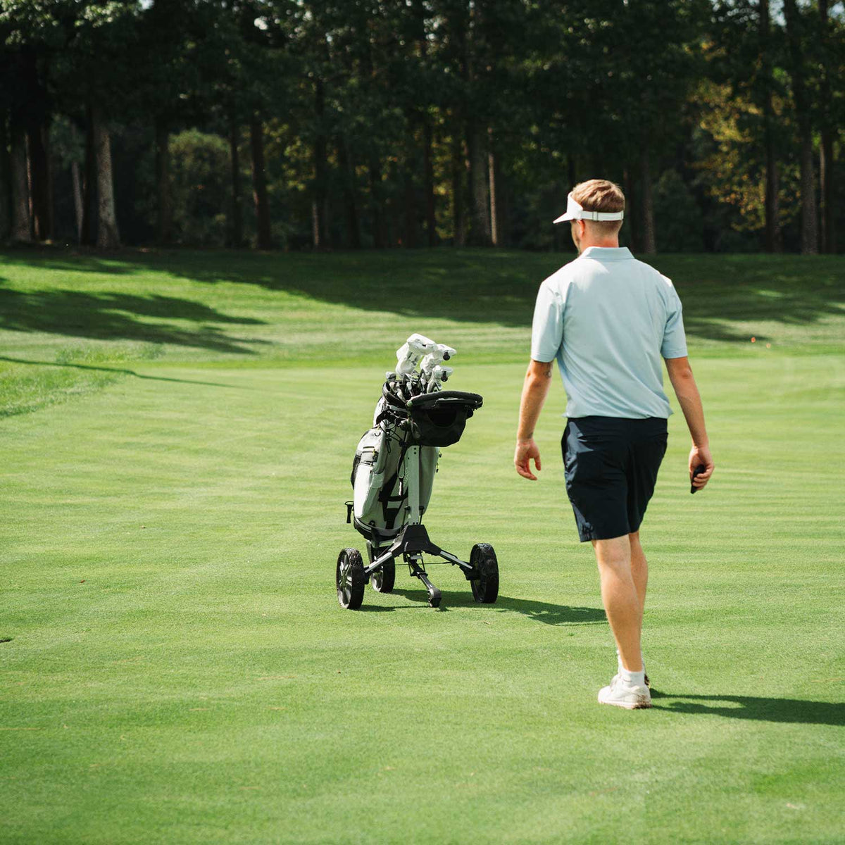 Bag Boy Volt golf cart, silver and black, lifestyle photo
