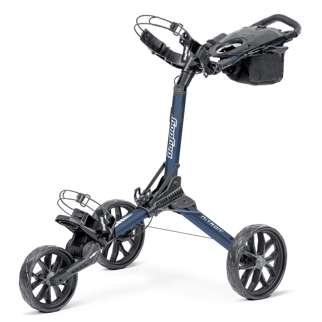 Studio view of the Bag Boy Nitron golf push cart in a navy and charcoal finish, showcasing its compact, four-wheel folding design and premium build for efficient course navigation.