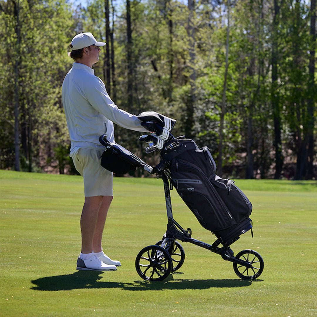 Golfer on a sunny fairway using the Motocaddy Nitron LTD USA Edition in gray and black, highlighting the premium design and ease of use of this electric golf cart.