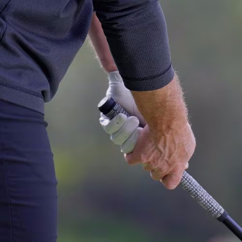 SKYTRAK smart grip sensor cap housing installed on a golf club handle to track swing data, grip alignment, and club physics data metrics.